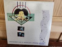 Front cover of the vinyl single, showing graphic art and title 'Promised You a Miracle' by Simple Minds.