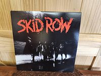 Front cover of Skid Row self-titled vinyl showing band members with red title