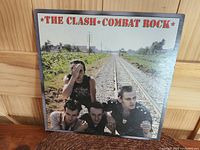 Front cover of The Clash Combat Rock LP album featuring band members and title text.