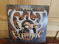 Front cover of The Cult Electric vinyl LP showing band logo and member images framed with artistic background.