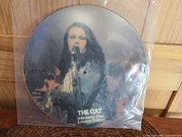 Front side photo disc image of lead singer of The Cult singing with microphone, wearing denim jacket.