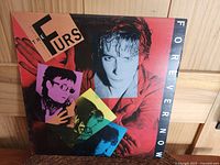 Front cover of The Psychedelic Furs Forever Now album showing band members' portraits and title graphics.
