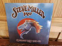 Front cover of The Steve Miller Band Greatest Hits 1974-78 album showing horse head logo on blue background