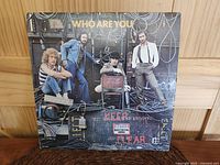 Front cover of 'Who Are You' LP album by The Who showing band members and cables.