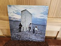 Front cover of The Who 'Who's Next' album showing band members and large rectangular monolith in a barren landscape.