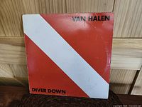 Front cover of Van Halen Diver Down vinyl LP, red with white diagonal stripe and text
