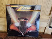 Front album cover showing the ZZ Top Eliminator artwork with vintage red car illustration and logo.