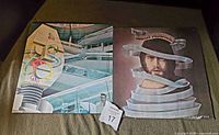 Two Alan Parsons Project LP vinyl albums lying side by side showing the front covers, 'I Robot' on the left and 'Tales of Mystery and Imagination' on the right.