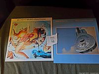 Front view of the two Dire Straits LP vinyl albums: Brothers in Arms and Alchemy - Dire Straits Live, side by side showing their covers.