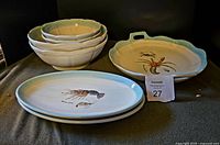 Full set displayed including large platter, bowls, and oval platters with seafood paintings