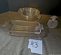 Image showing all three items: round clear glass bowl with ribbed spiral pattern, rectangular clear glass tray with handles, and frosted glass perfume bottle