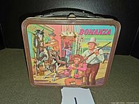 Front view showing illustrated Bonanza cowboys and horse scene with the show title.