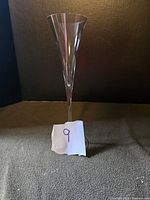 Single Ashley crystal champagne flute against a dark background with a paper number 9 in front.
