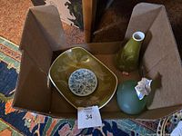 Box containing the dishes, pottery vases, and glass bottle, showing all items together