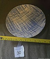 Single dinner plate with Blue Dell abstract blue brushstroke design and measuring tape showing approx 10.5 inches diameter