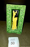 Front view of vintage Shawnee USA pottery double block vase with yellow deer figure in green ivy frame.