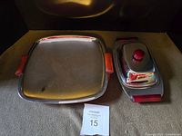 Photo of the vintage chrome serving tray with cherry red Bakelite handles and the oval covered serving dish with a cherry red Bakelite knob.