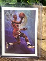 Front of the 1990 Hoops Michael Jordan NBA Bulls card showing artwork of Jordan performing a slam dunk.