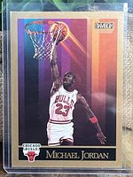 Front of 1990 Skybox Michael Jordan NBA card showing Jordan dunking as number 23 of Chicago Bulls with colorful background and team logo