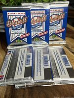 Six sealed 1991 Upper Deck Major League Baseball card packs, blue and silver foil wrapping with 1991 Edition and hologram details visible.