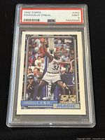 Front view of the 1992 Topps Shaquille O'Neal rookie card graded PSA 9 Mint, showing O'Neal in action with Orlando Magic uniform.