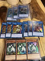 Three foil Link Spider cards, three foil Honeybot cards, three foil Decode Talker cards and three foil Ram Clouder cards arranged on wooden surface.