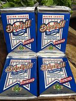 Four sealed 1991 Upper Deck baseball card packs arranged in a 2x2 grid showing front packaging with branding and series info