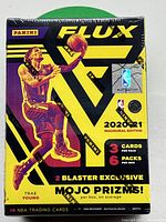 Front of sealed 2020-21 Panini Flux NBA trading cards blaster box with Trae Young image and product details.