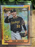 Front of Paul Skenes baseball card showing player in Pirates black jersey, holographic silver background with geometric pattern, and 'All Star Rookie Cup' trophy logo.