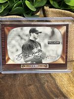 Front of Roy Halladay card showing black and white photo with facsimile signature and wood-grain border.