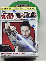 Front view of sealed Star Wars: The Last Jedi trading cards box featuring Rey.