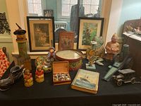 Overview of vintage toys, games and framed prints on black table