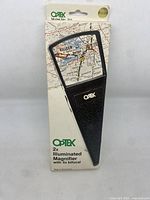 Optex branded box for 2x illuminated magnifier with 4x bifocal, front view showing vintage style packaging and price label.