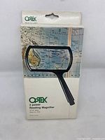 Front view of the Optex reading magnifier box featuring product image and branding.