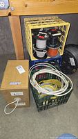 Overall view of crates holding multiple spools of insulated electrical wire and a box with an electrical cable.