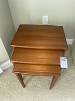 Top-down stacked view of the three wooden nesting tables.