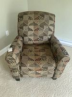 Front view of the recliner chair showing the full seat and backrest upholstery and armrests.