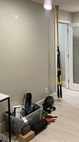 Overview of TRX straps, storage bin, dumbbells and other floor items