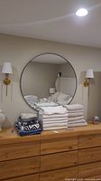 Mirror, sconces and towels displayed on dresser