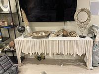 Front view of sideboard showing decorative façade and three closed drawers