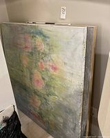 Stacked view of large 48×48 pastel floral canvas and grey abstract canvas leaning against wall