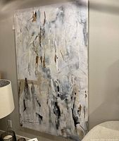 Full view of the abstract painting mounted on a wall, showing scale relative to nearby furniture