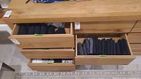 Four open drawers showing rolled and folded activewear