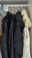 Overall view of four jackets hanging on rack
