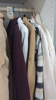 Six assorted jackets hanging on rack showing full lot