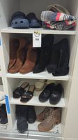 Various women's shoes on shelving including boots, sandals, slip-ons, and an Aritzia tote bag on top shelf.