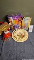 Photo of lot showing Disney Best Friends 12 board books, Disney Winnie the Pooh concept set with CD and six books, My Barnyard Buddies toy, and Royal Doulton bunny-themed ceramics plate and bowl.