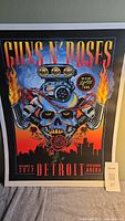 Full view of the Guns N' Roses 2017 Detroit concert tour poster showing artwork, text, colors, and size reference.