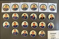 Front view of 22 New York Rangers hockey coins from 1961-62 season, showing colorful player portraits including Harry Howell, Doug Harvey, and Jean Ratelle. Coins are in coin sleeves or loose, with some duplicates.