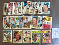 Top view of a selection of 1969 Topps baseball cards showing various players and team names, including rookies and stars, arranged in rows.